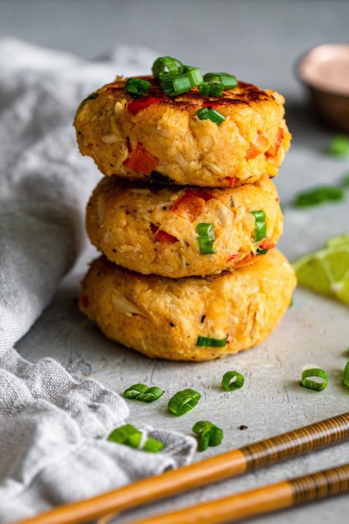 Air Fryer Sriracha Tuna Cakes in a stack on a grey background.