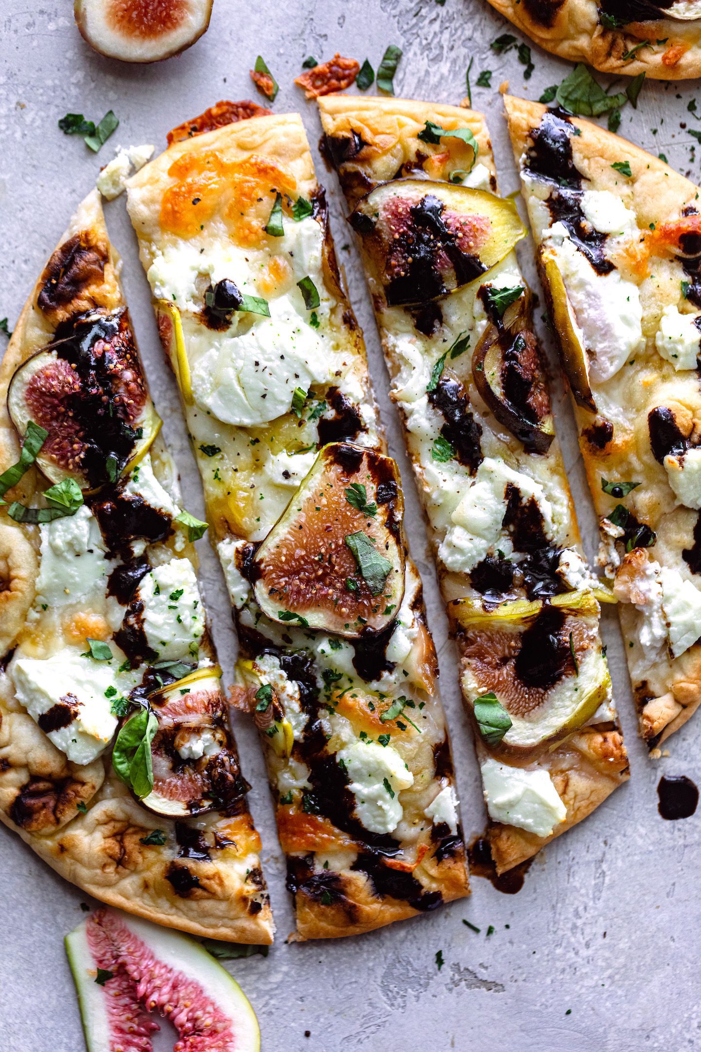 Sweet and savory fig balsamic naan flatbreads with goat cheese, mozzarella, and fresh basil - the perfect summer appetizer!
