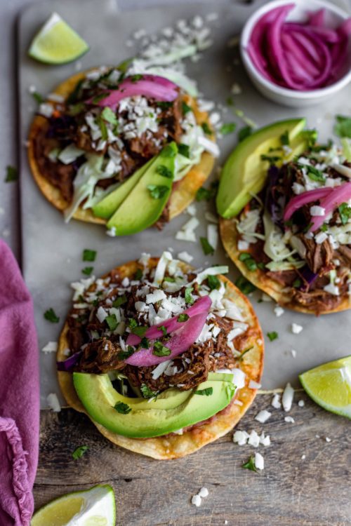 3 Barbacoa Stackers topped with pickled red onions, cotija cheese, cilantro, creamy avocado and fresh lime.