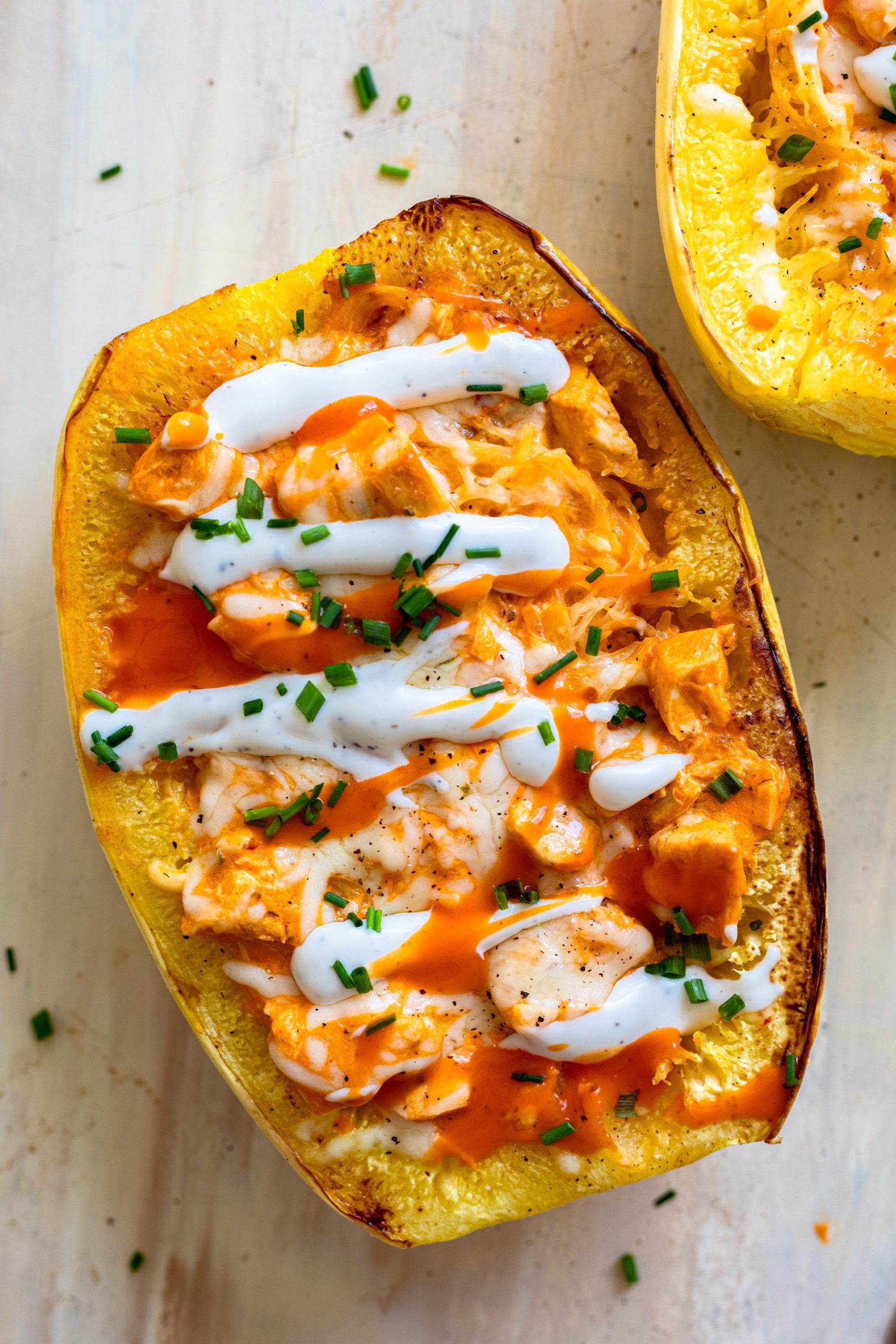 Baked spaghetti squash topped with homemade buffalo chicken, sour cream and chopped chives. 